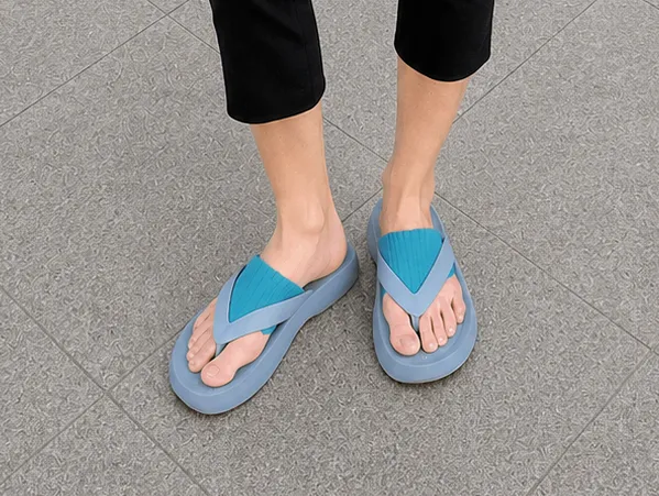 Turquoise flip flop socks paired with blue flip flops, featuring breathable summer knit socks with a split toe design for casual warm-weather styling.